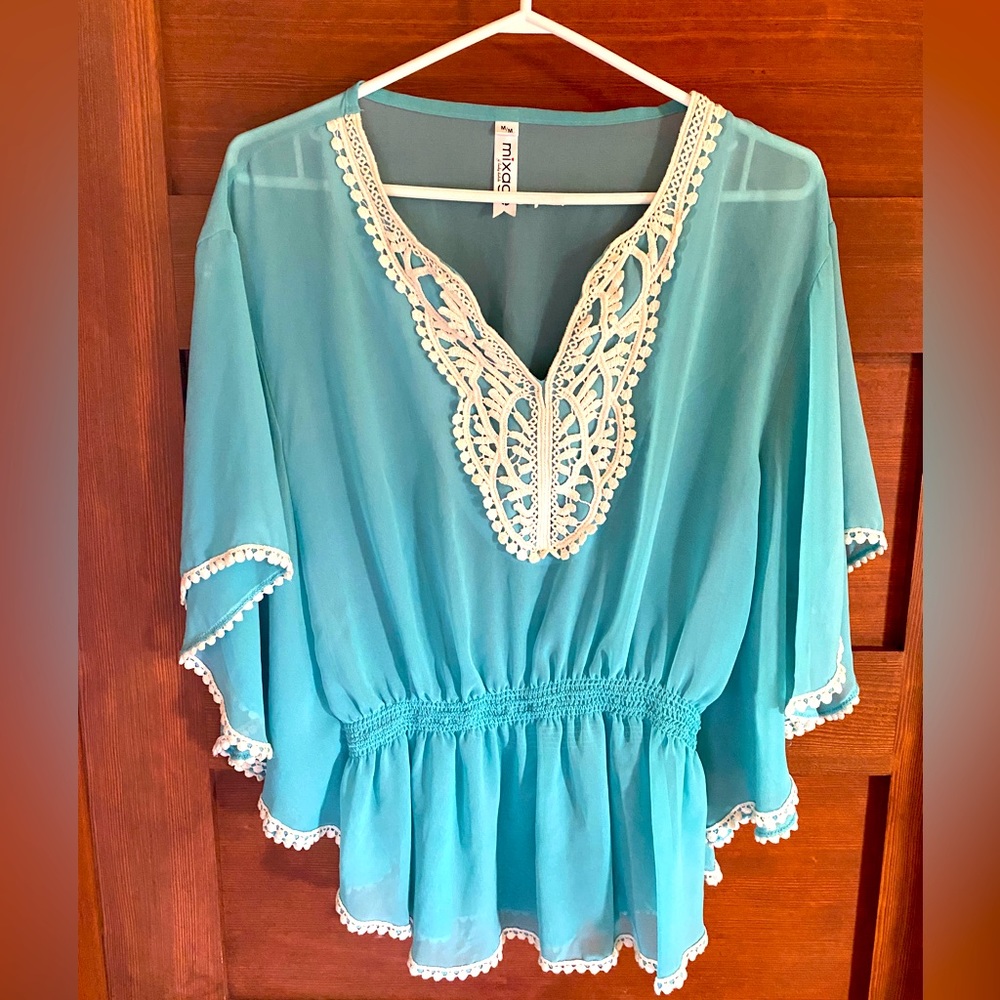 Blouse with detailed trim in light blue teal, size medium.